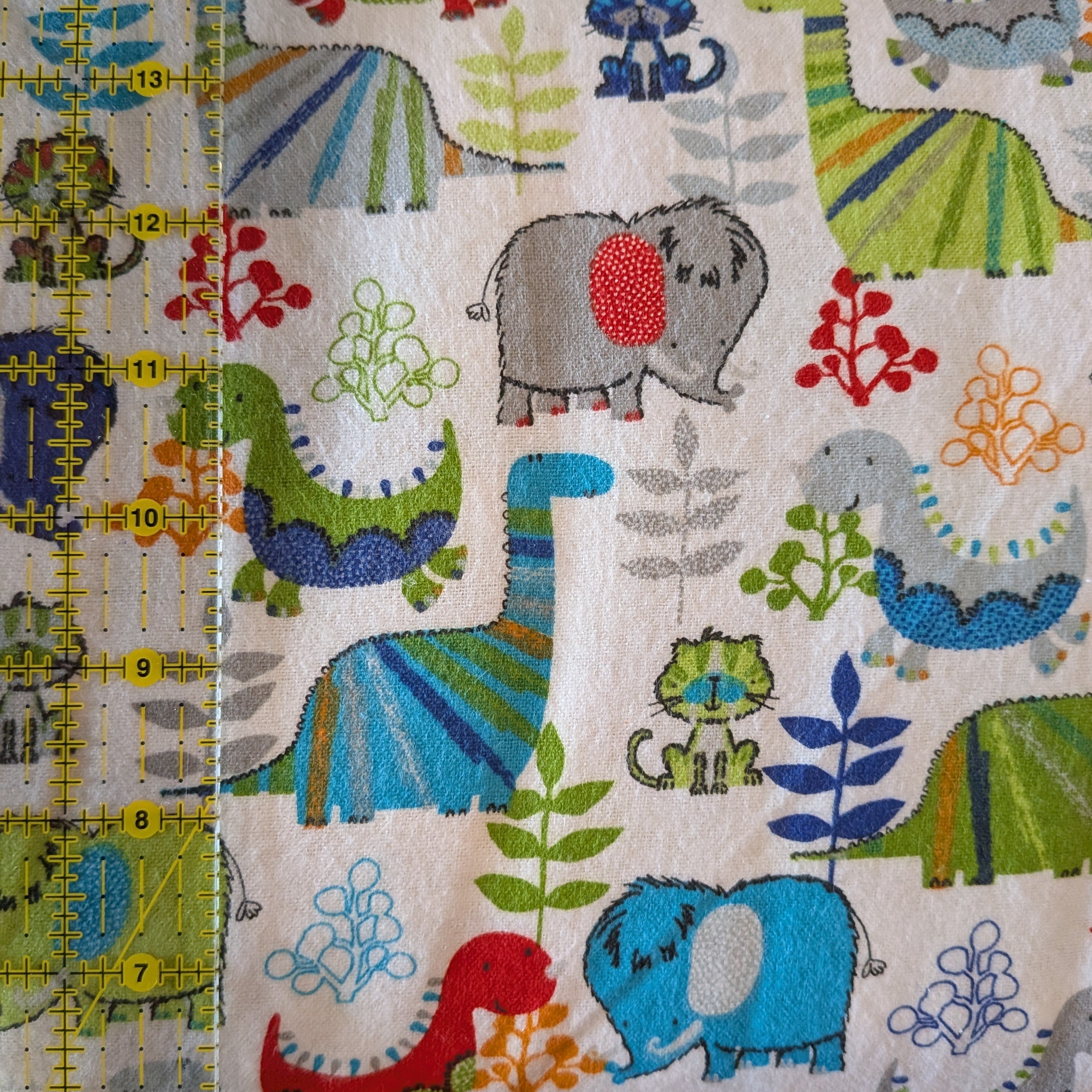 3 Wishes Fabric ~ DINO TOSS ~ FLANNEL ~ White and Multi~ Sold by the 1/2 Yard