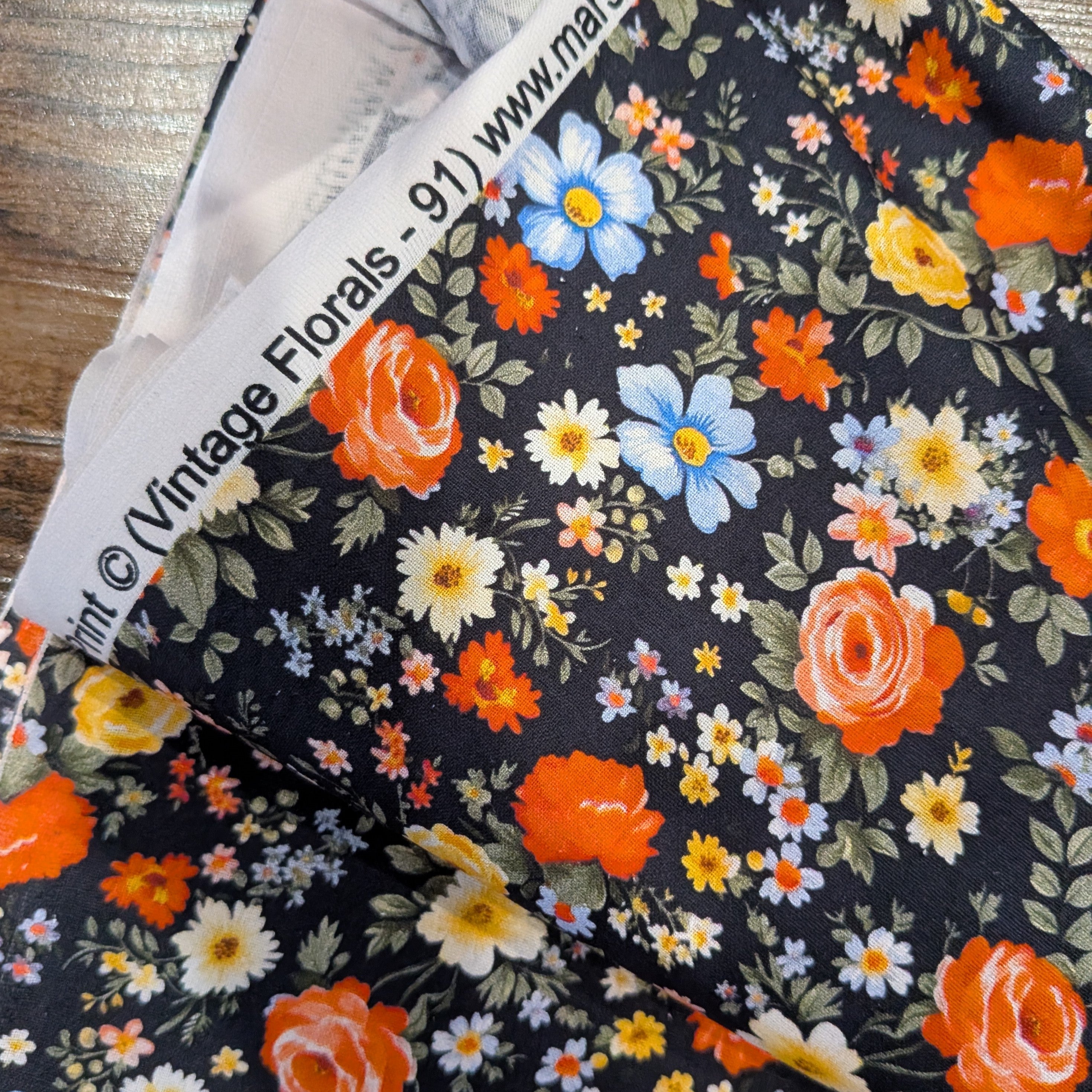 Marshall Dry Goods ~ VINTAGE FLORAL 91 ~ Orange, Blue and Yellow Flowers on Black Background ~ Sold by the 1/2 Yard
