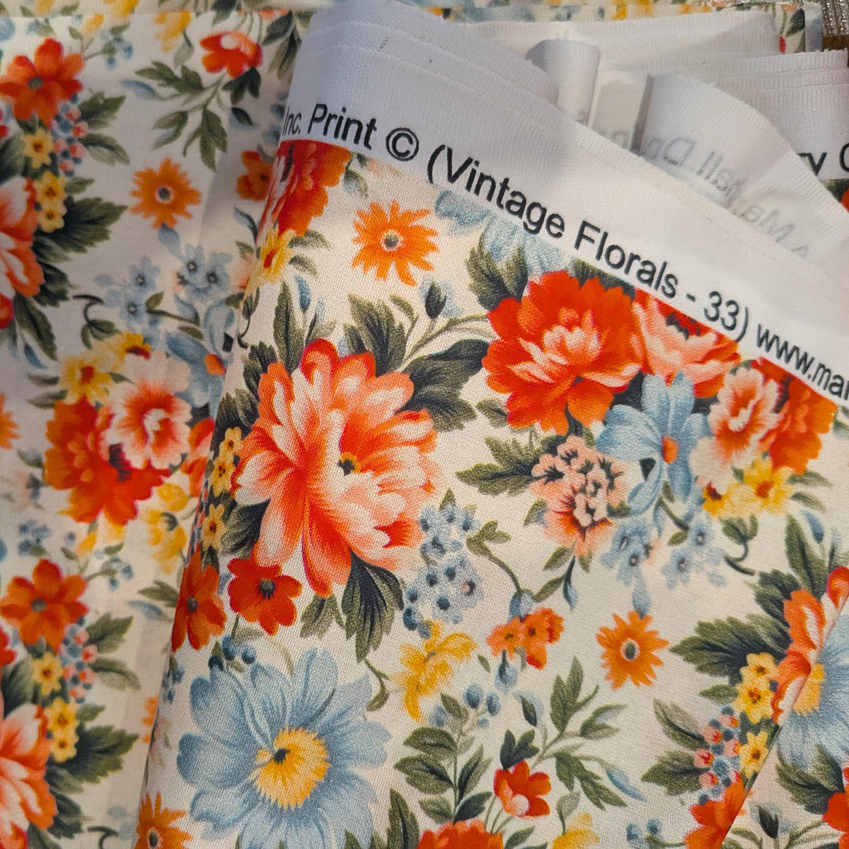 Marshall Dry Goods ~ VINTAGE FLORAL 33 ~ Reddish Pink, Blue, Orange and Yellow Flowers on Cream Background ~ Sold by the 1/2 Yard